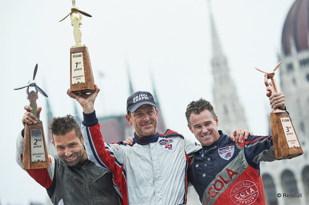 Matthias Dolderer of Germany (C) celebrates with Hannes Arch of Austria (L) and Matt Hall of Australia (R) during the Award Ceremony at the fourth stage of the Red Bull Air Race World Championship in Budapest, Hungary on July 17, 2016. // Armin Walcher / Red Bull Content Pool // P-20160717-00737 // Usage for editorial use only // Please go to www.redbullcontentpool.com for further information. //