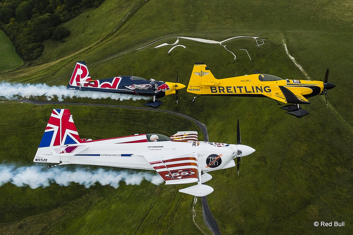 Nigel Lamb and Paul Bohomme of Great Britain give Peter Besenyei of Hungary an aerial view of their home country ahead of the weekend\'s Red Bull Air Race World Championship stop in Ascot over the Uffington White Hores in the Oxfordshire countryside near Oxford in the United Kingdom on August 11, 2015.