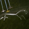 Nigel Lamb and Paul Bohomme of Great Britain give Peter Besenyei of Hungary an aerial view of their home country ahead of the weekend\'s Red Bull Air Race World Championship stop in Ascot over the Uffington White Hores in the Oxfordshire countryside near Oxford in the United Kingdom on August 11, 2015.