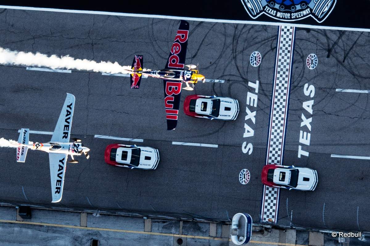 Kirby Chambliss of the United States flies in formation with Hannes Arch of Austria prior to the sixt stage of the Red Bull Air Race World Championship over the Texas Motor Speedway in Fort Worth, United States on September 04, 2014.