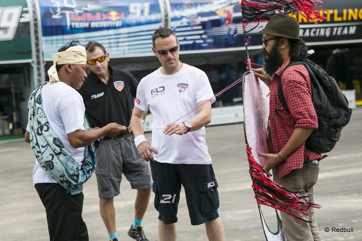 Matthias Dolderer of Germany & Nicolas Ivanoff of France learning how to fly a traditional Malaysian kite called the Wau at the race airport during the Red Bull Air Race Putrajaya 2014 in Putrajaya, Malaysia on May 14th 2014.