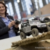 Eine Mitarbeiterin von Revell GmbH lenkt das funkgesteuerte Modellauto von Axial, ein Modell aus der Reihe Rubicon, ueber eine Bruecke (An employee of Revell GmbH steers the radio-controlled model car Axial, a model from the range Rubicon, over a bridge)