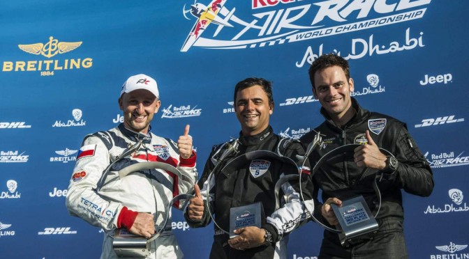 Matt Hall of Australia (L), Paul Bonhomme of Great Britain (C) and Pete McLeod of Canada (R) celebrateduring the Flower Ceremony of the first stage of the Red Bull Air Race World Championship in Abu Dhabi, United Arab Emirates on February 14, 2015. // Balasz Gardi/Red Bull Content Pool // P-20150214-00180 // Usage for editorial use only // Please go to www.redbullcontentpool.com for further information. //